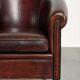 Vintage sheepskin club armchair with decorative nails and black piping