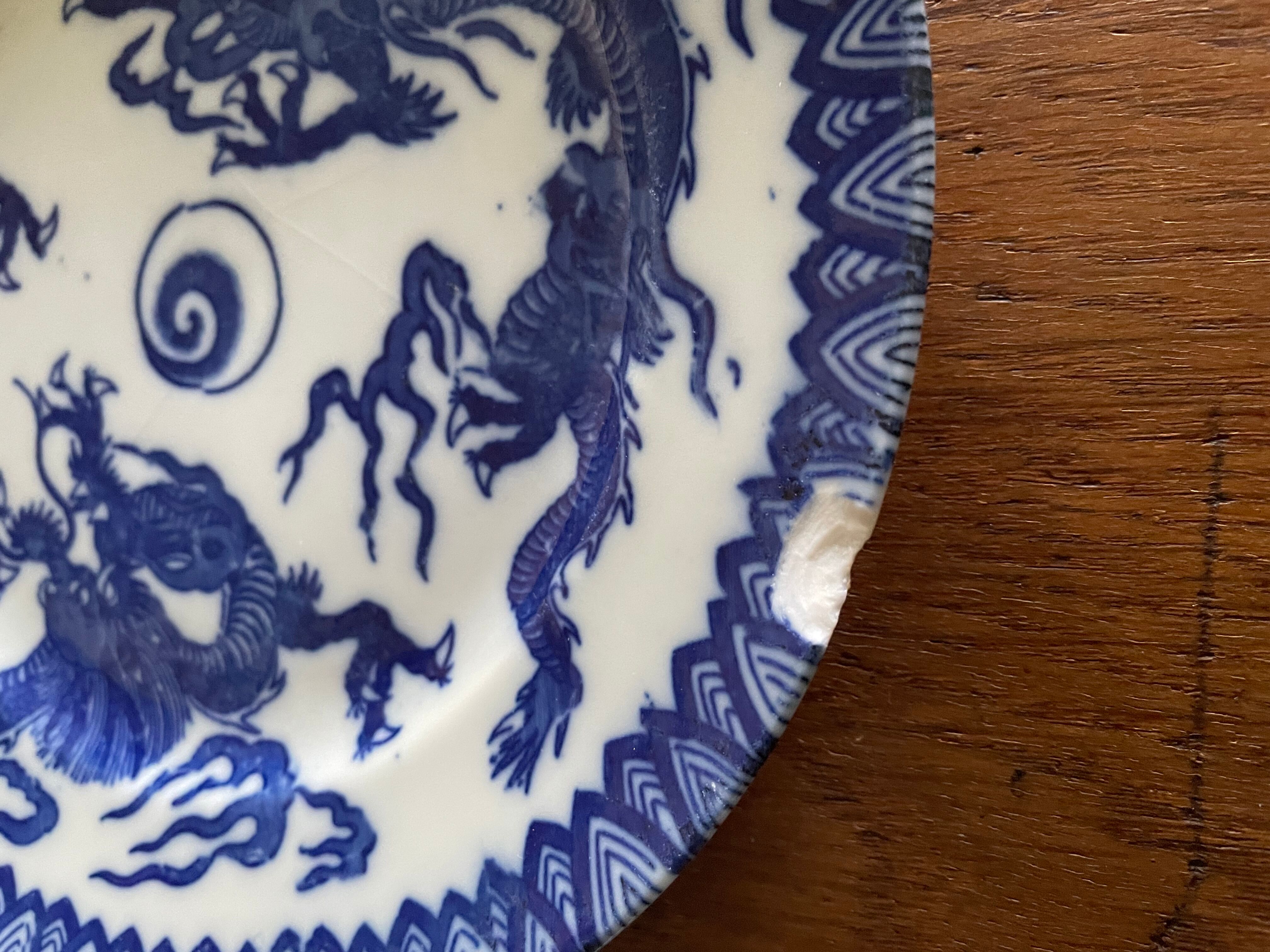 Asian porcelain plates decorated with blue dragons