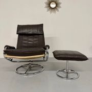 Vintage leather reclining armchair and its 1970s designer ottoman.