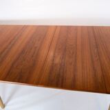 Dining table in teak and oak with extensions designed by Hans J. Wegner