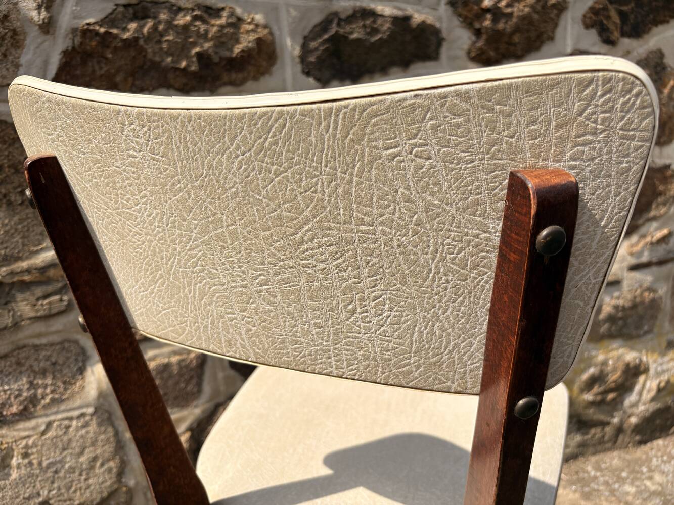 Pair of vintage chairs with upholstered backrest and seat, 1950s style.