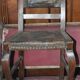 Pair of brown embossed leather chairs with brass studs and wooden frame, 1900s