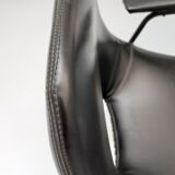 Pair of armchairs, Tonneau model, in black skai by Pierre Guariche, 60s