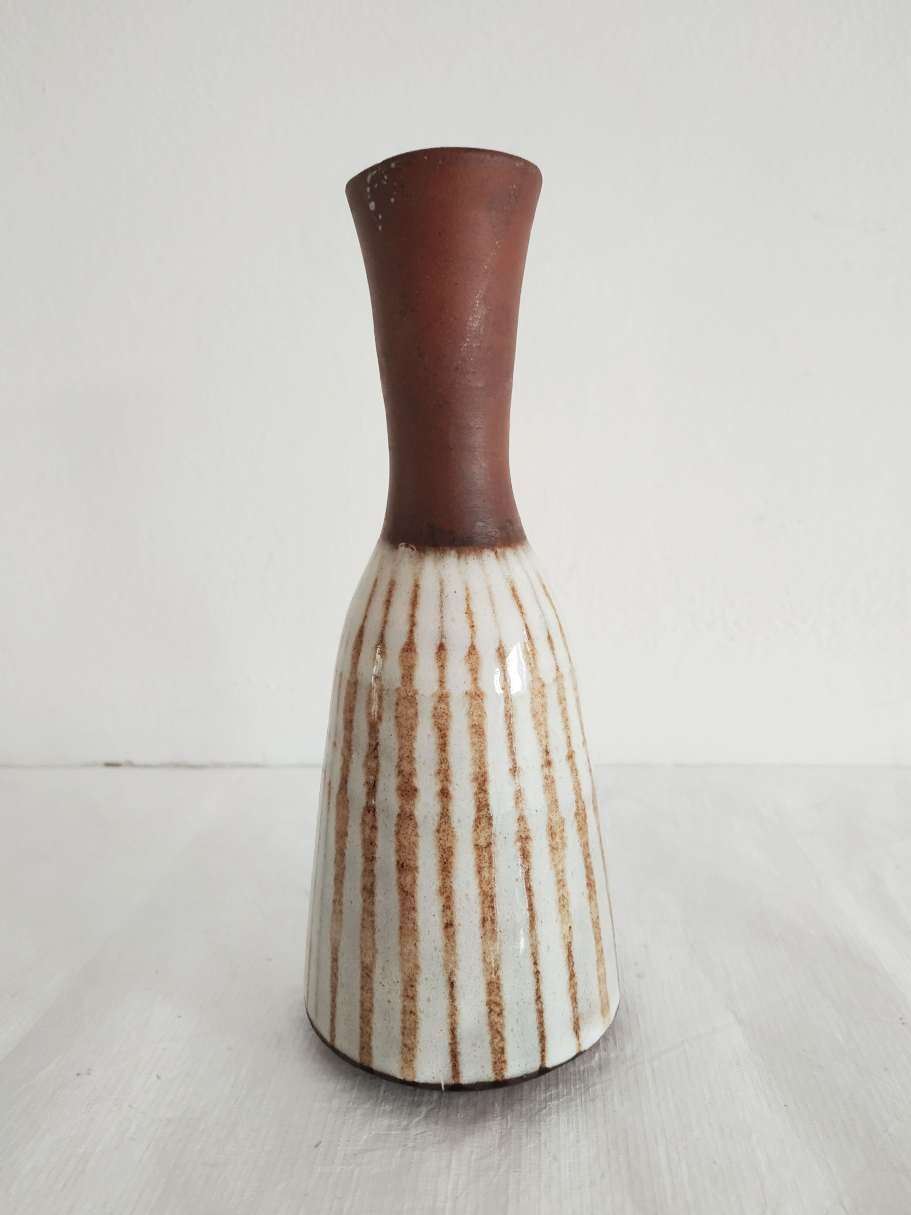 Small brown vintage vase with white enamels