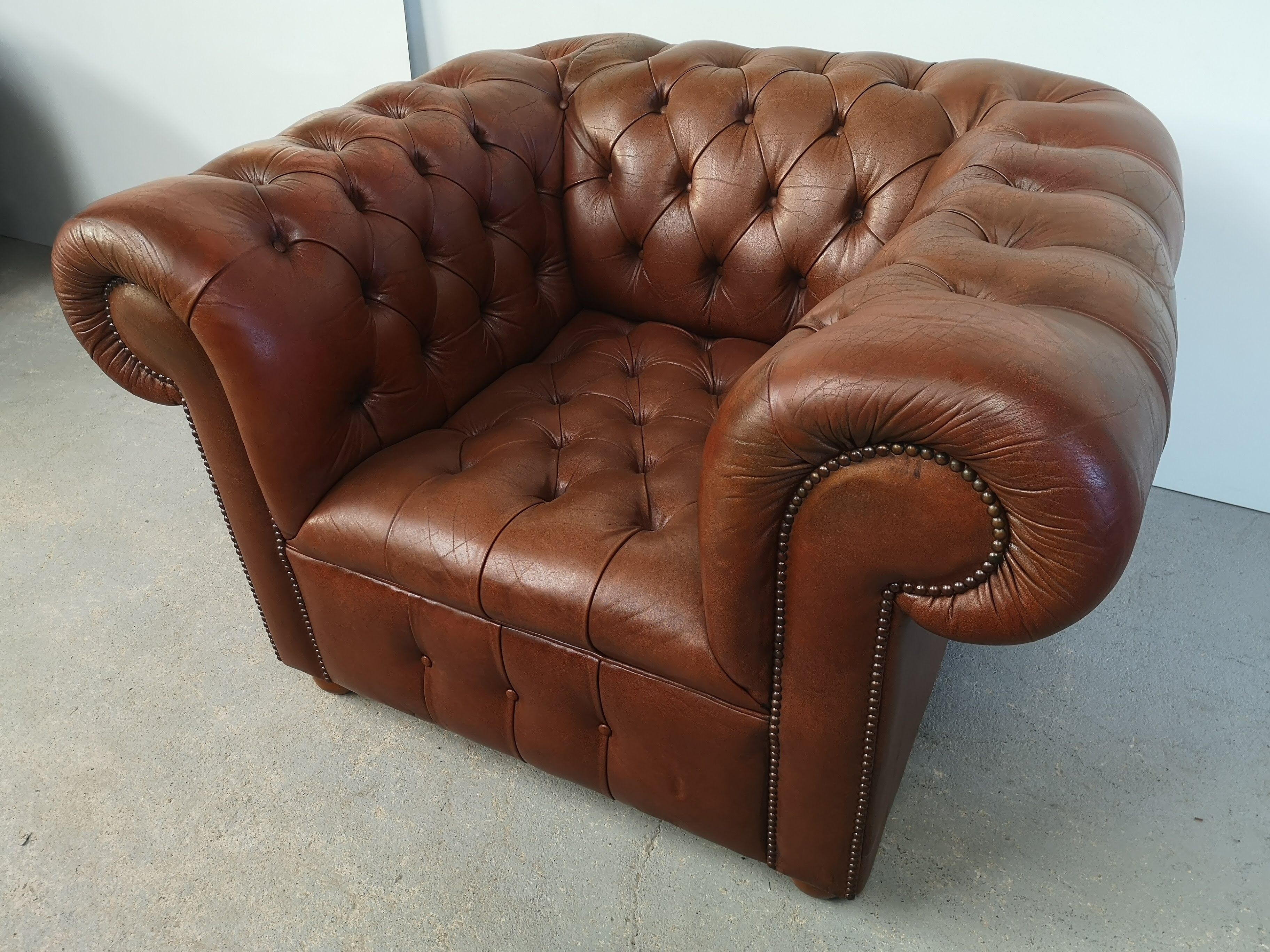 Brown leather chesterfield armchair