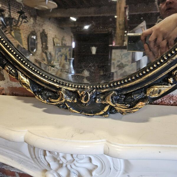 Ancien miroir ovale patiné noir et doré style louis xv