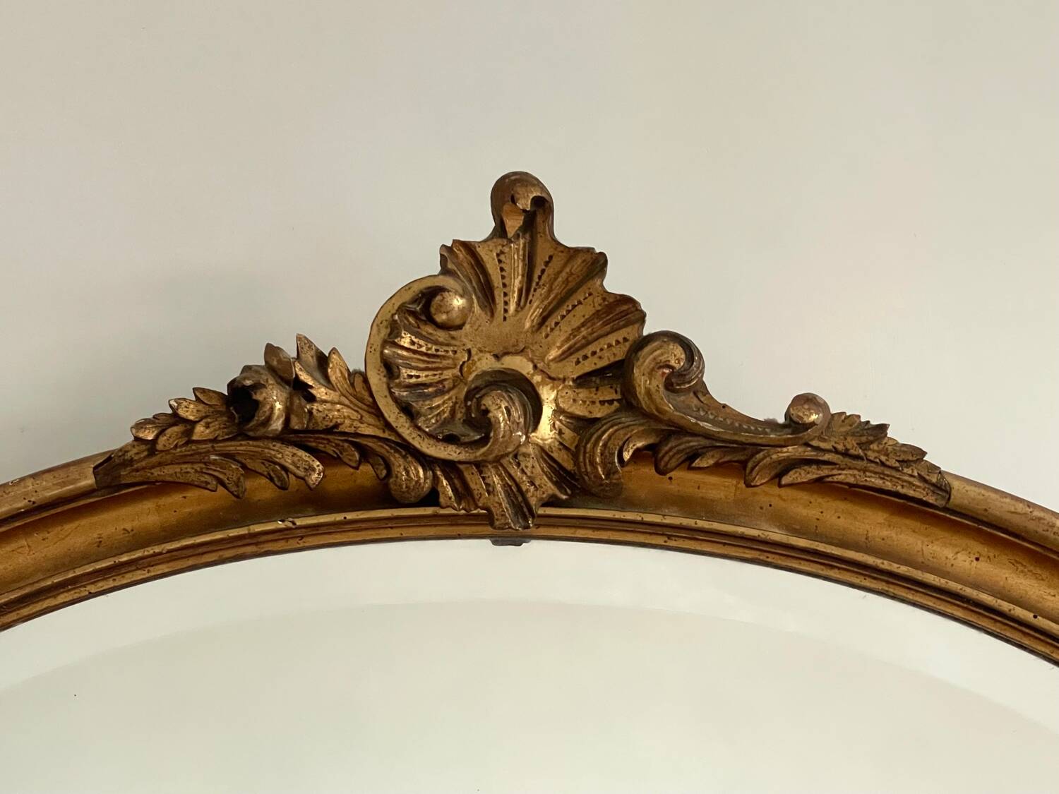 Antique oval gilt mirror.