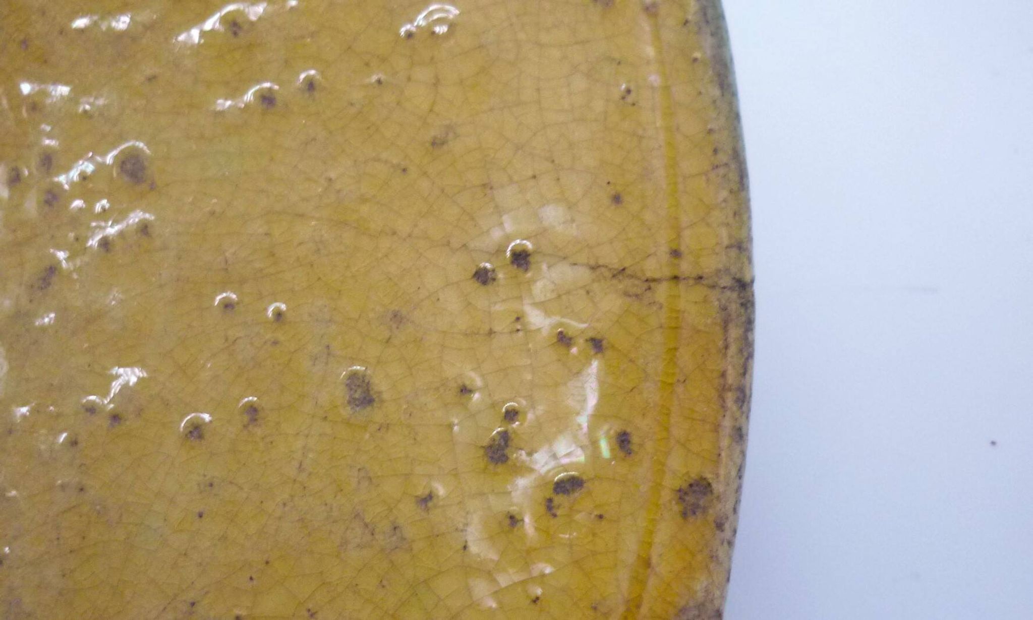 Old omelette turner, glazed yellow terracotta, south of France.