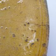 Old omelette turner, glazed yellow terracotta, south of France.