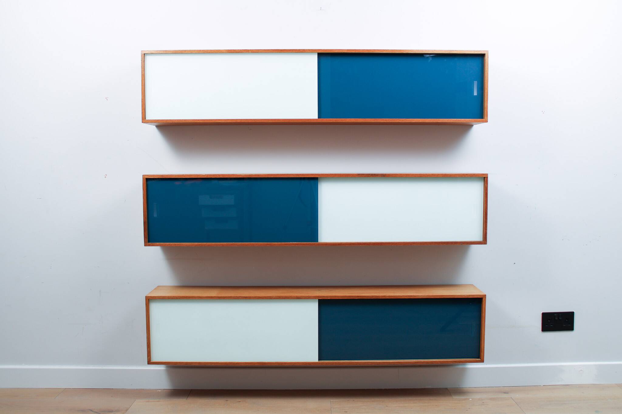 Vintage mid-century wall hung oak cabinets, blue & white sliding glass door