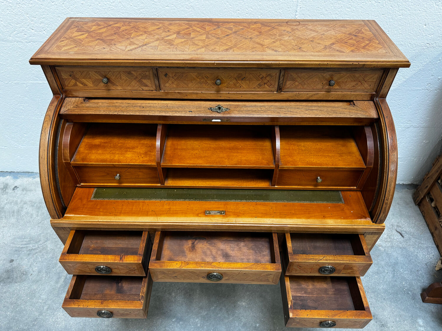 Cylinder desk with marquetry featuring a crosshatch design.