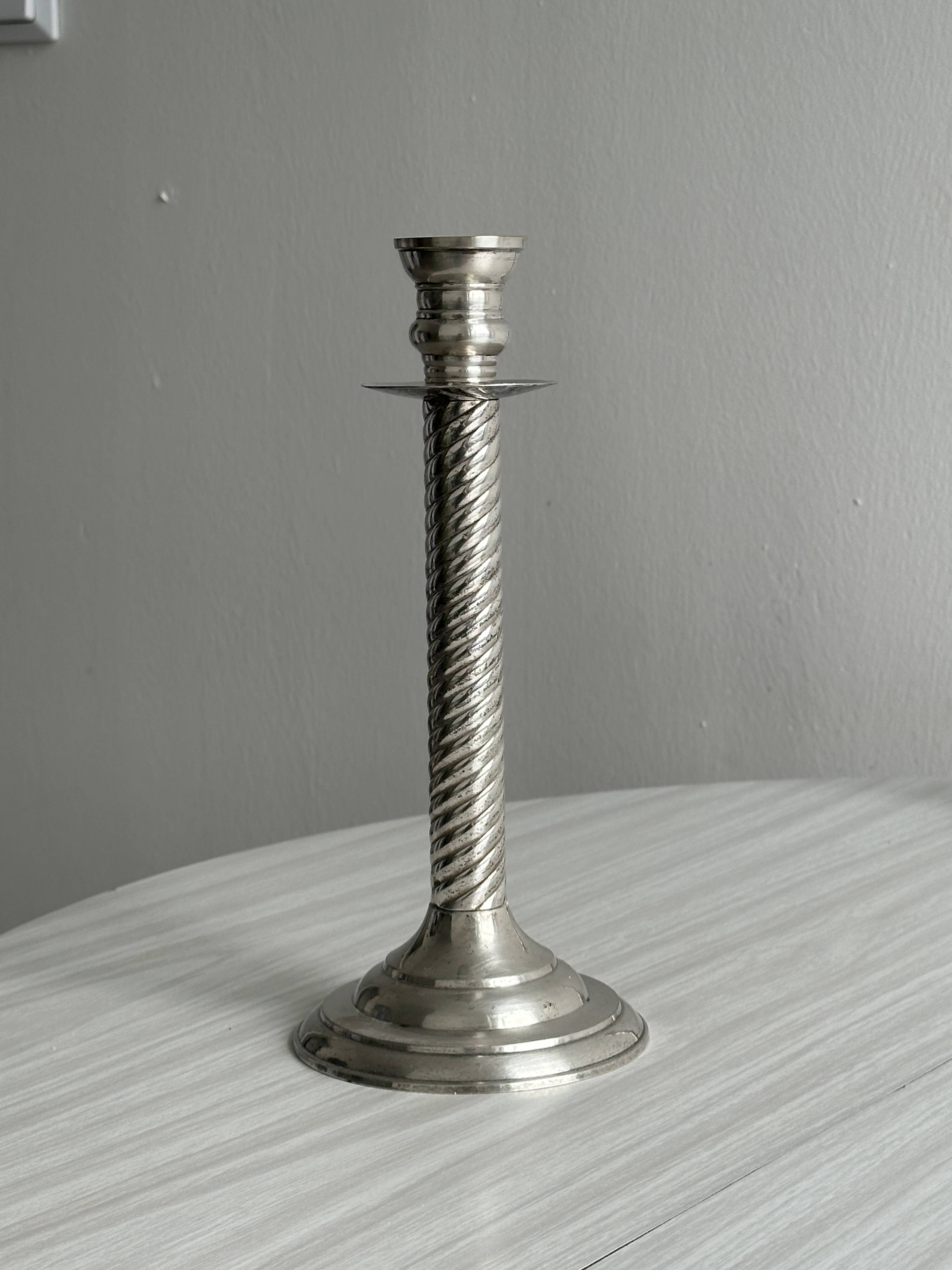 Patinated silver-plated metal candlesticks