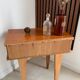 Vintage bedside table with tapered legs.