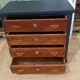 Vintage commode revamped in matte black & wood with warm tones.
