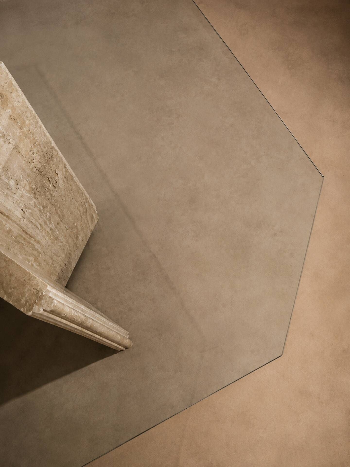 Dining table in travertine and smoked glass.