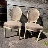Pair of cerused chairs with fabric seats and caned backs.