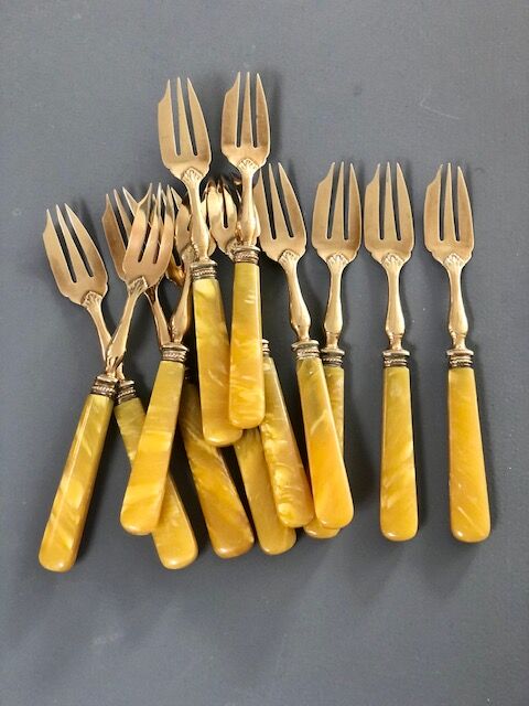 Brass and yellow galathite cake forks