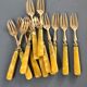 Brass and yellow galathite cake forks