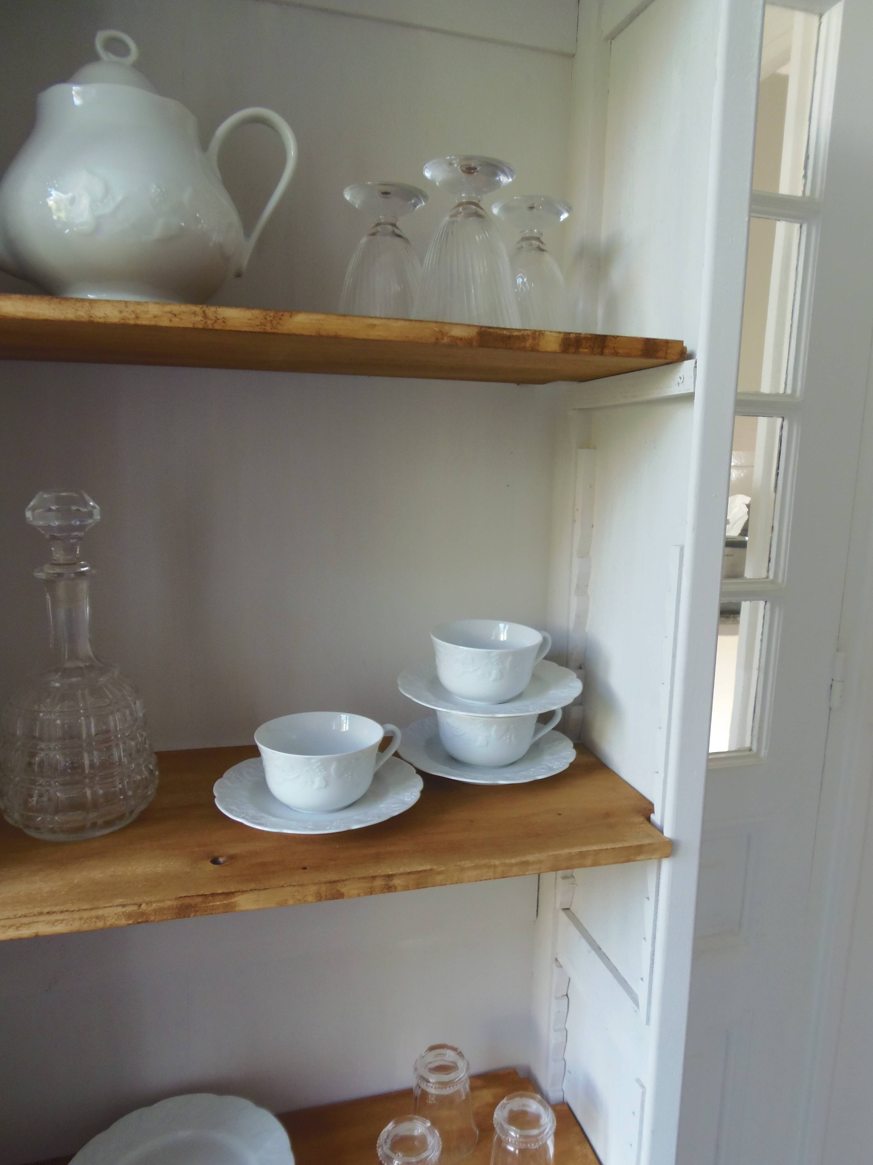 Shallow depth bookcase re-enchanted in pearl gray, wooden shelves.