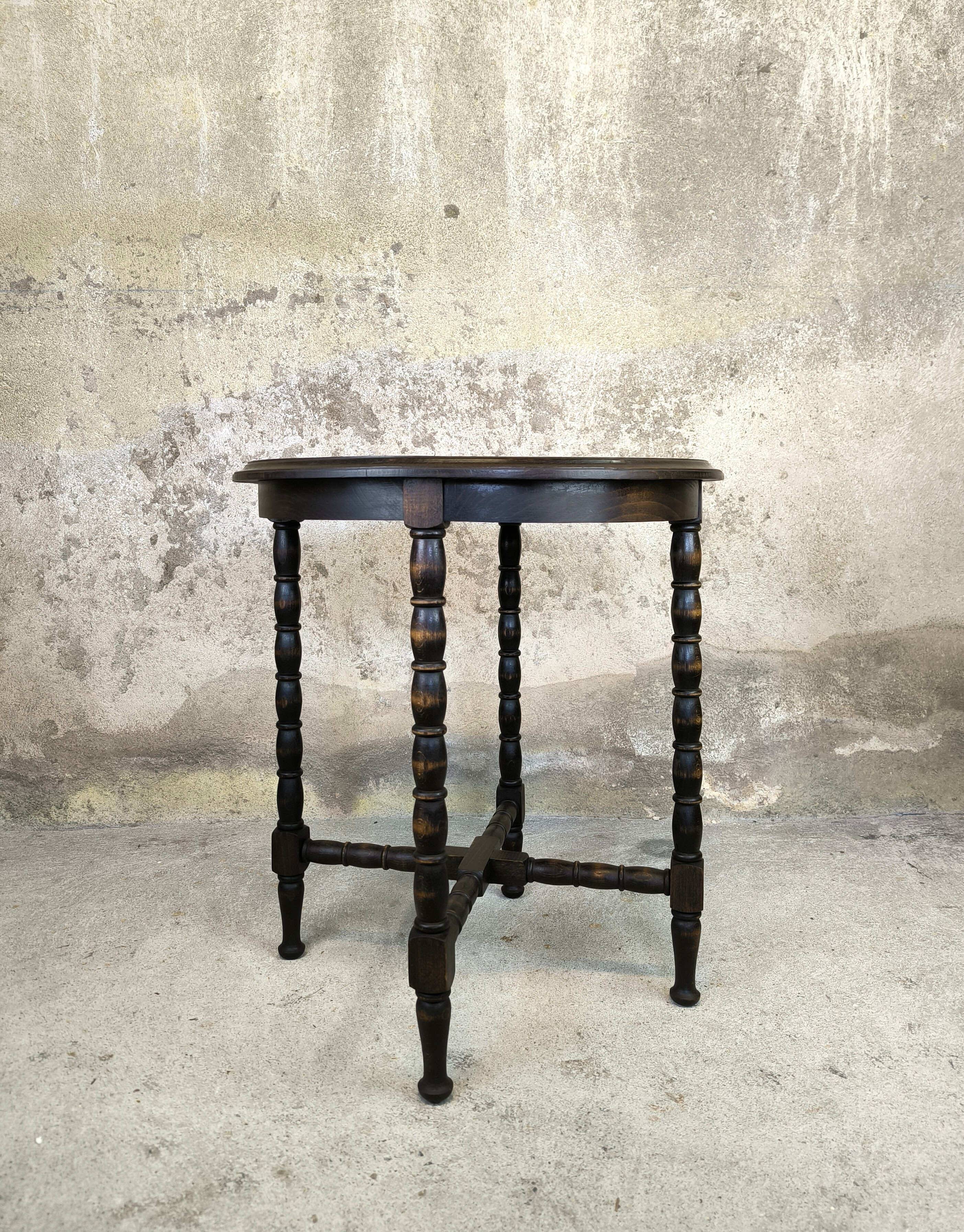 Vintage gueridon with beaded wooden legs.