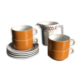 Hot chocolate cups and milk jar