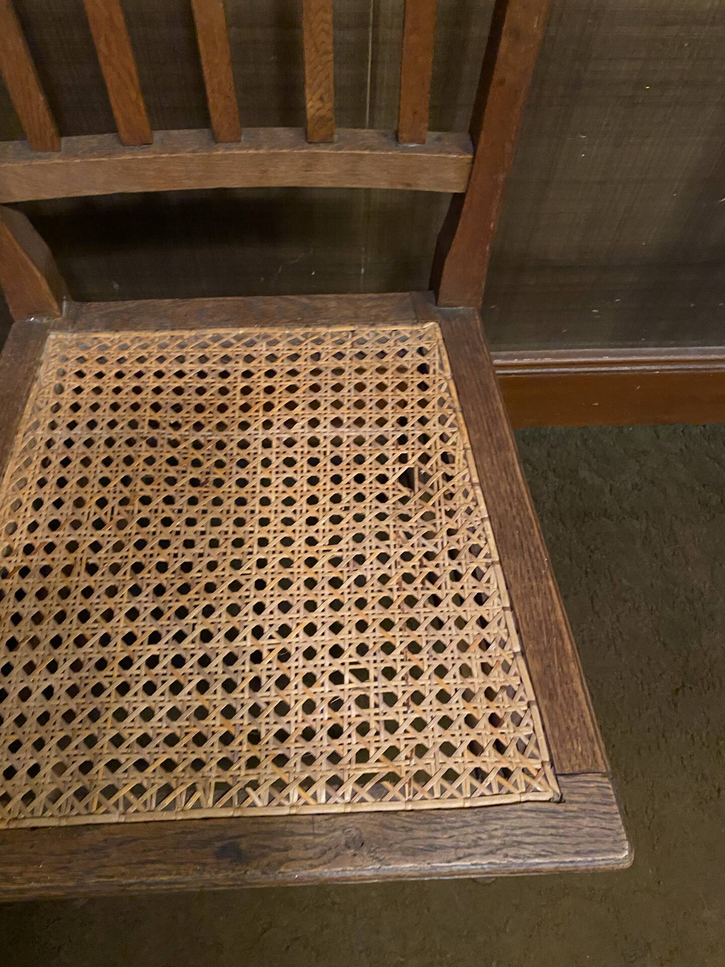 Set of 2 antique wooden chairs with caned seats.