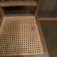 Set of 2 antique wooden chairs with caned seats.