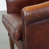 Sheepskin club armchair, correct finishing with decorative nails
