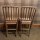 Set of 2 antique wooden chairs with caned seats.