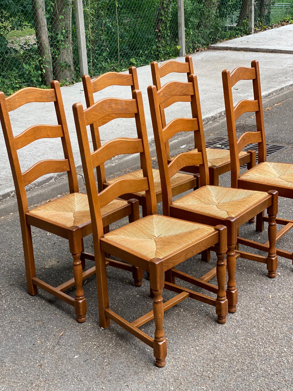 6 solid oak dining chairs with rush seats from the 1980s.