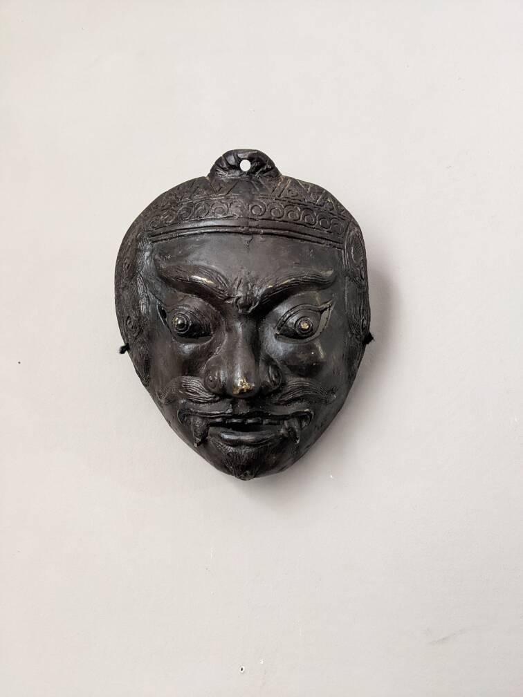 Ancient Indonesian bronze mask antique ethnic decoration tribal theater