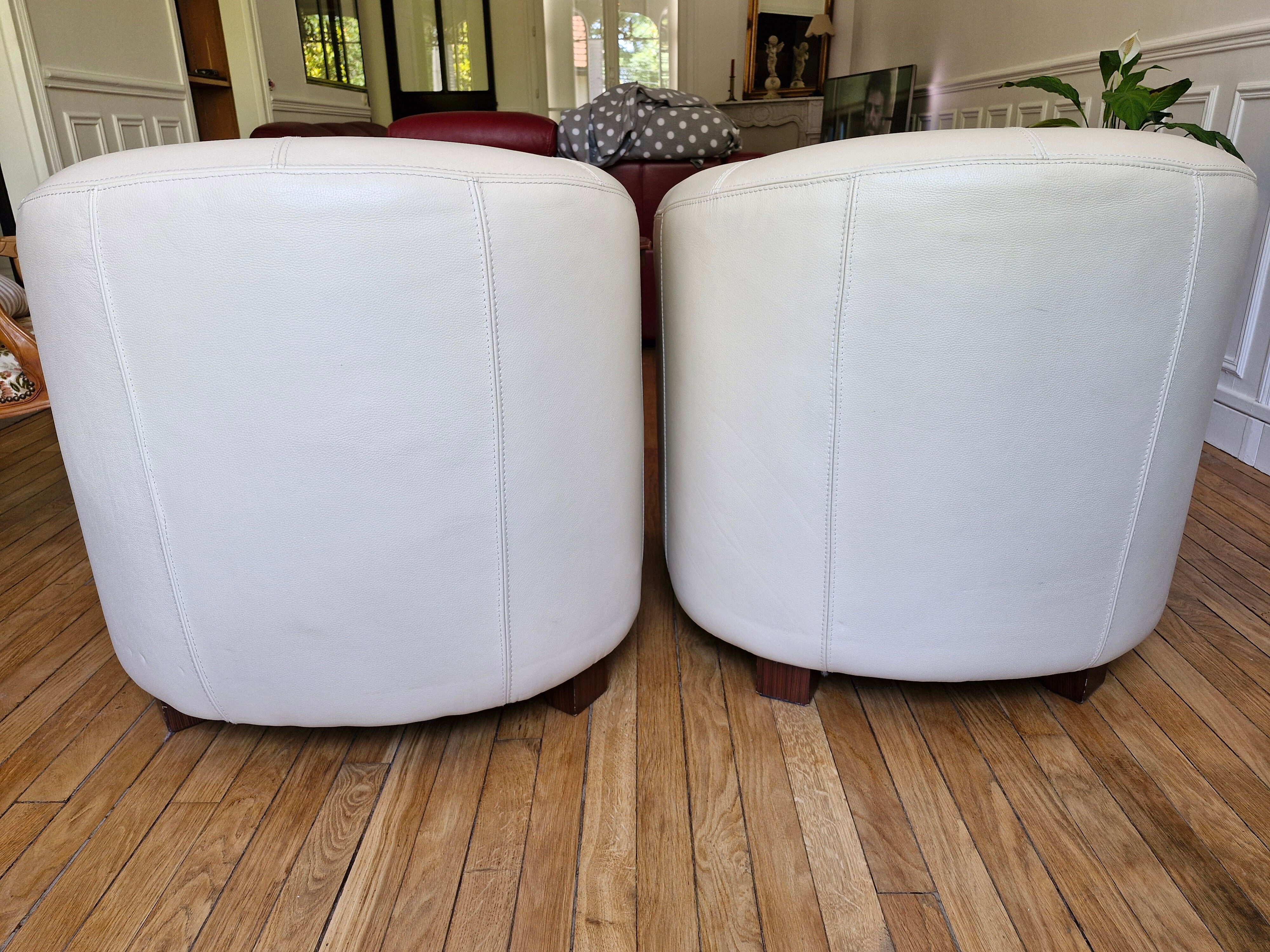 A pair of genuine leather club armchairs.
