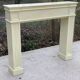 Fireplace surround with beige solid wood mantel