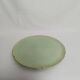 Large pastel green plate with a golden rim.