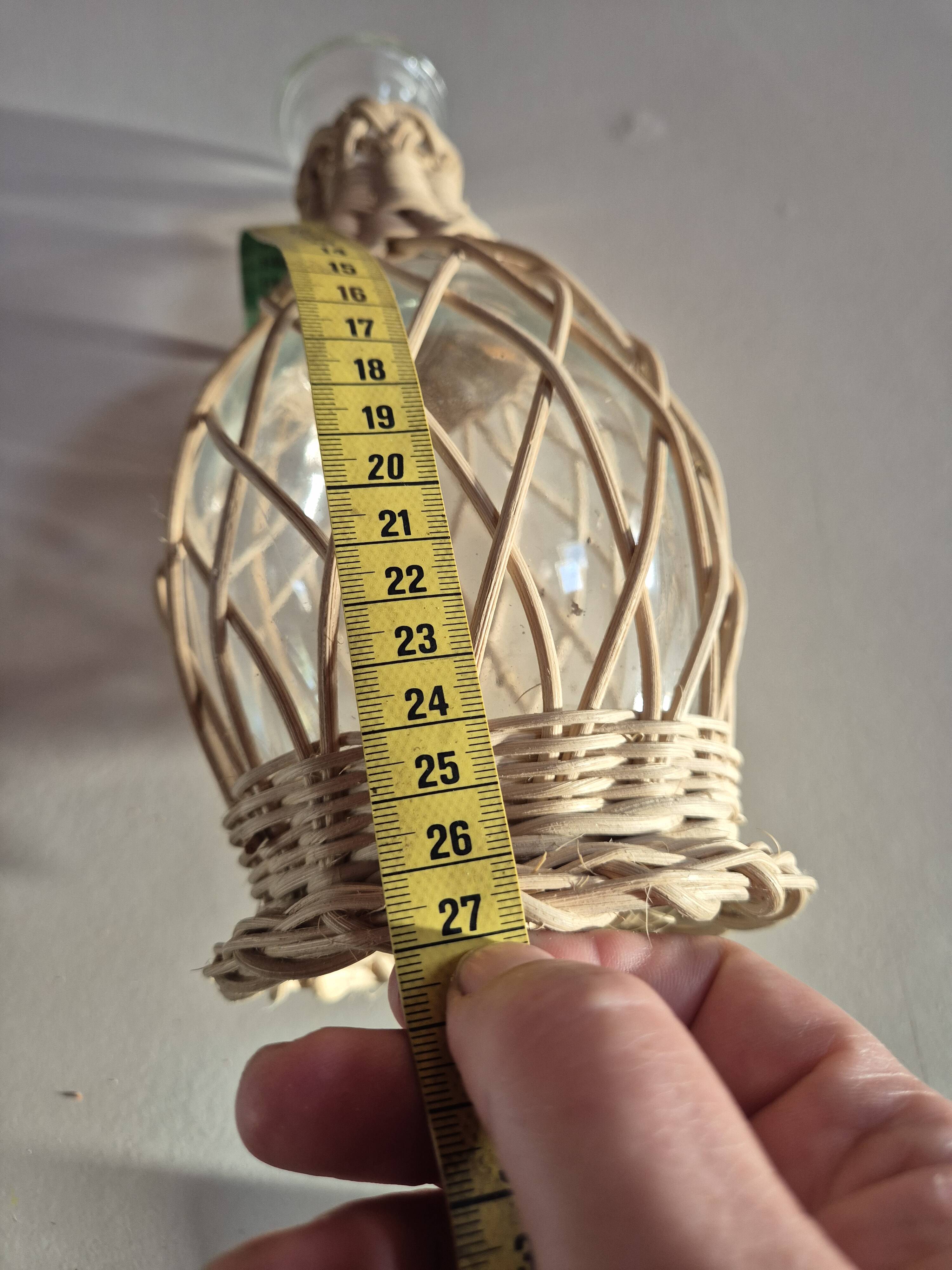 vintage glass vase surrounded by woven rattan