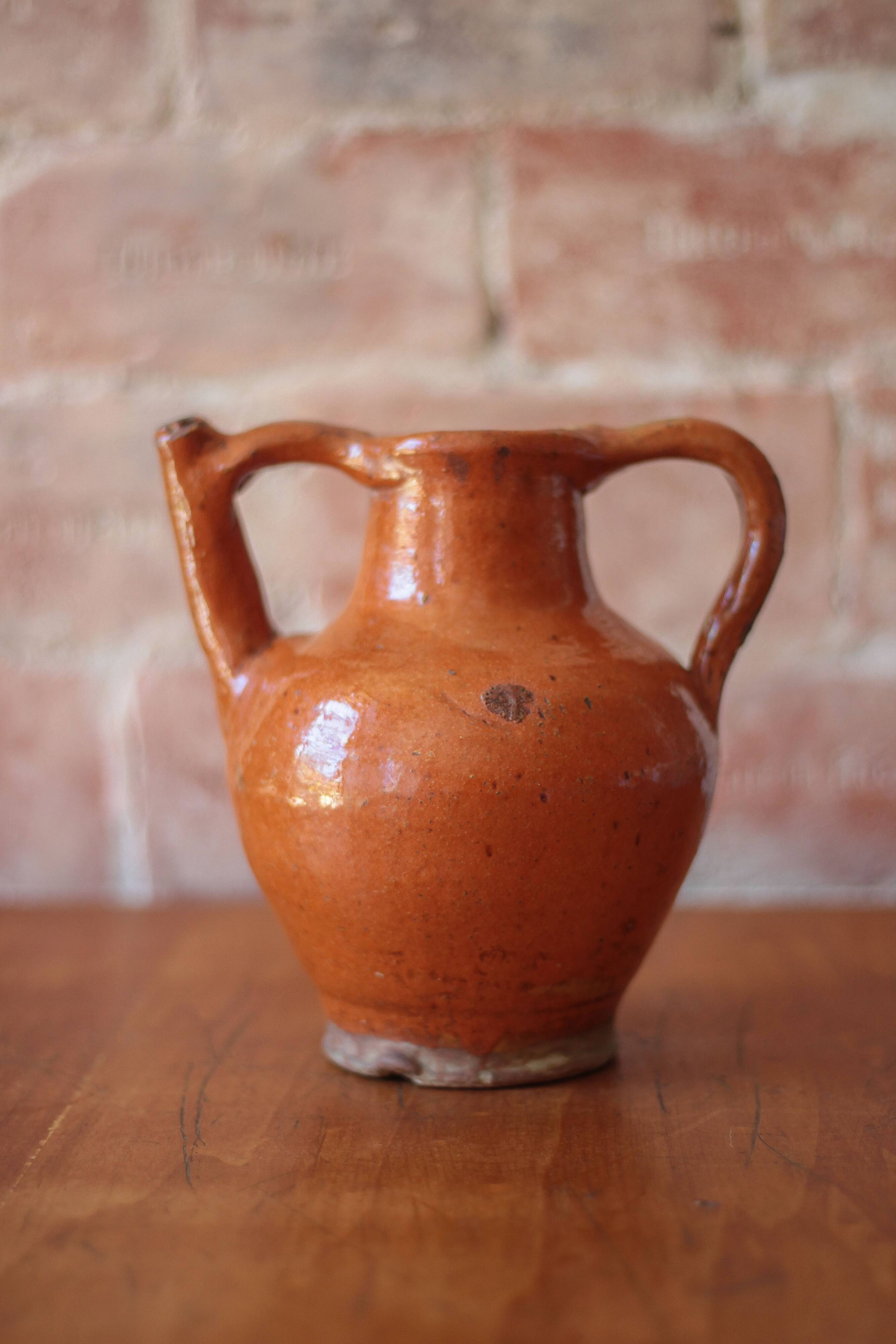 Ancient Orjol jug in orange glazed terracotta from South West France, 19th century.