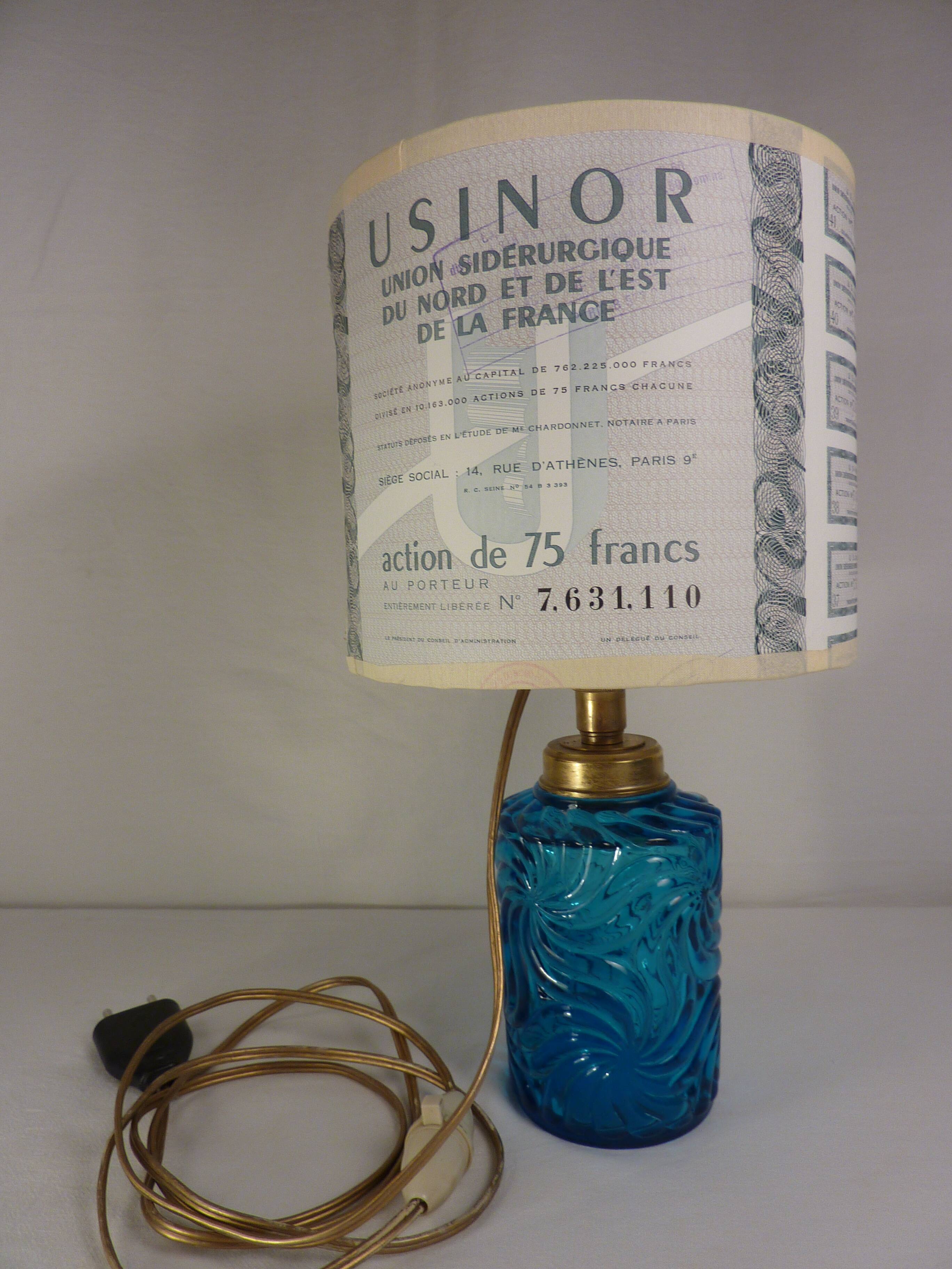 Table lamp with king blue and gold glass foot and machineinor action lampshade