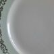Old mismatched earthenware dinner plates with gold accompanied by a dish
