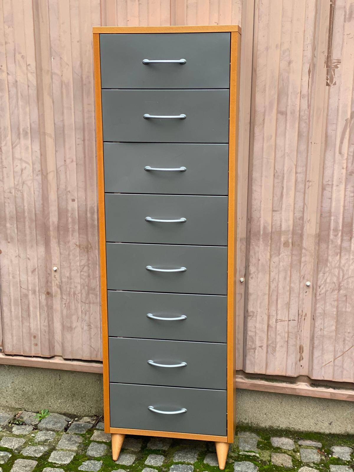 Scandinavian shoe storage cabinet in grey wood and metal.