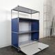 USM Haller furniture in gentian blue and white with a drop-down door on wheels.