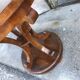 Art Deco side table in brown walnut, round top and scroll legs, France 1930s.