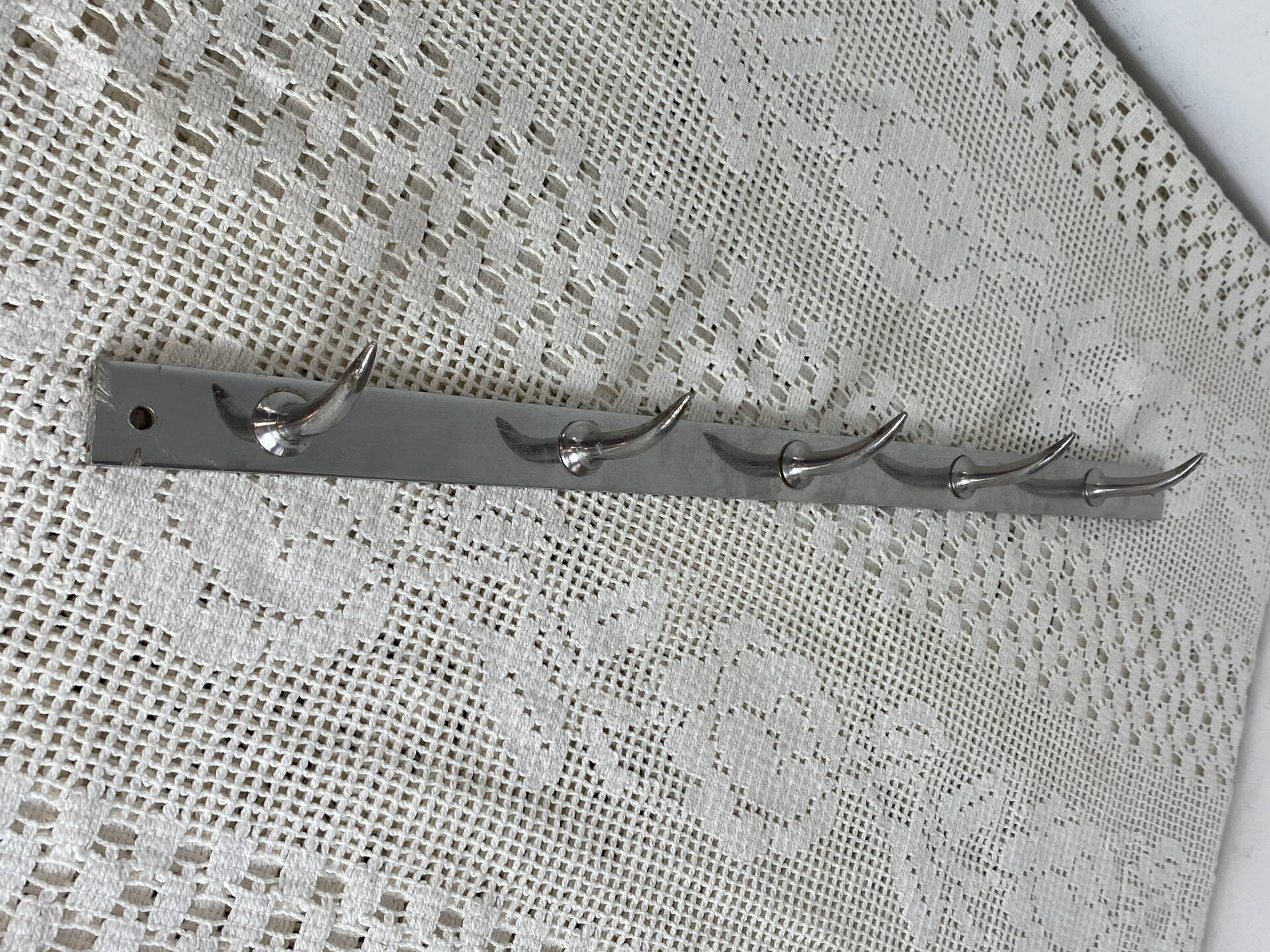 Stainless steel butcher's hook, known as a "wolf tooth bar."