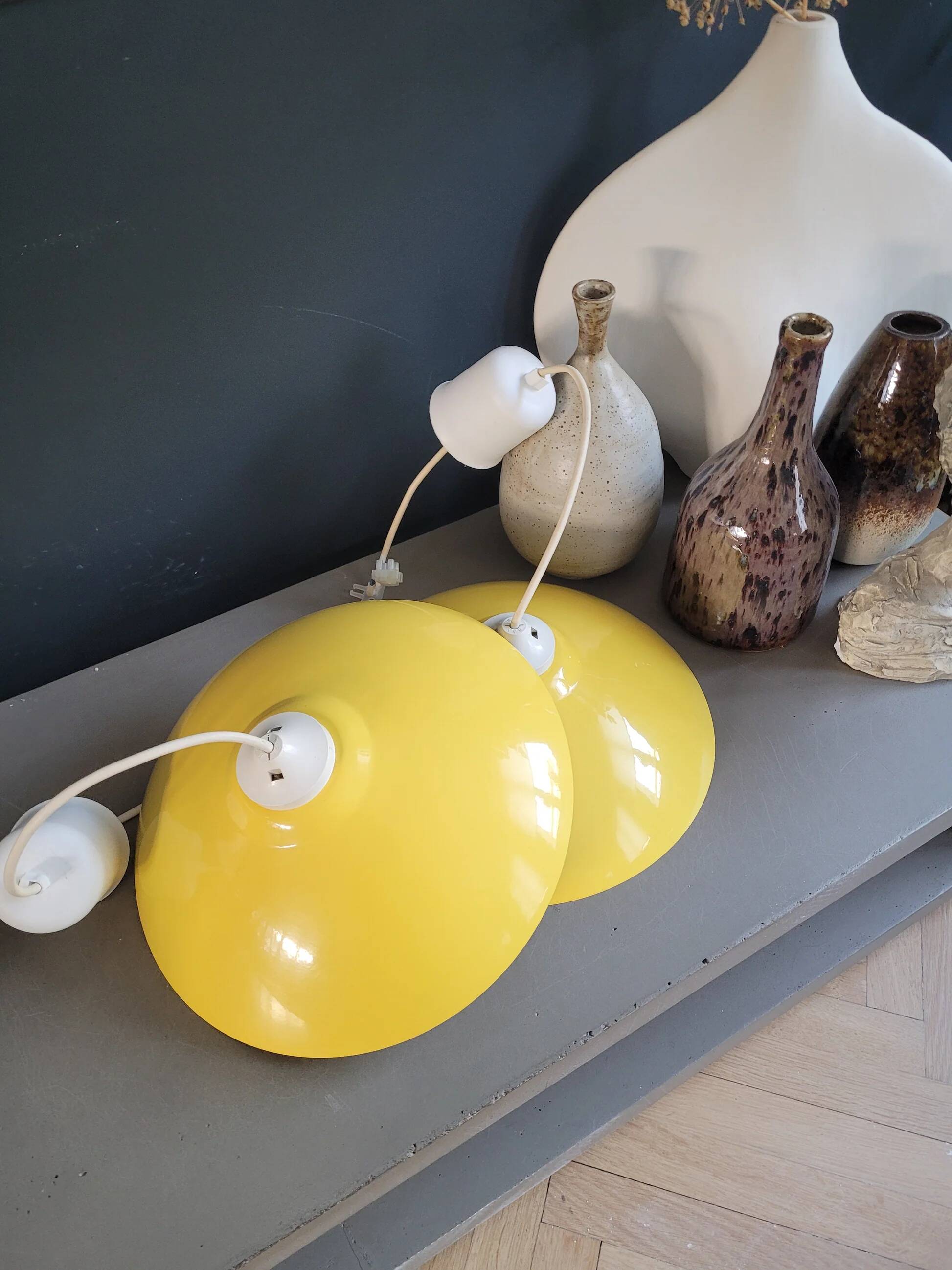 Pair of yellow lacquered metal pendant lights