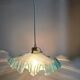 Suspension lampshade with scalloped edges in blue and its interior decoration.