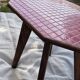 Small Scandinavian side table with wood and pink tiles, with tapered legs.