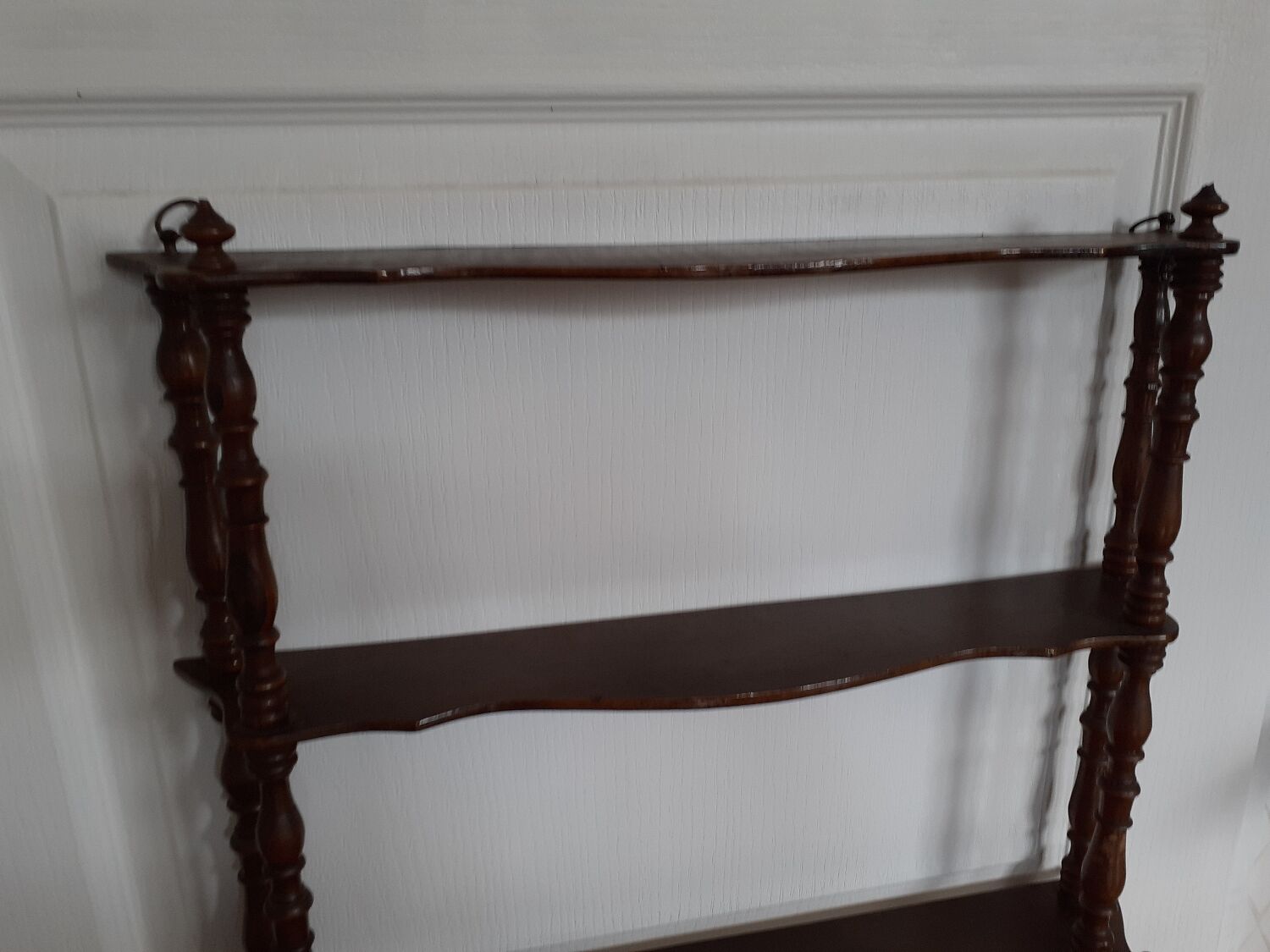 Turned wooden wall shelf
