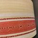 Hanging lamp with brass-coloured details, made of fabric with intact plastic bottom grille.