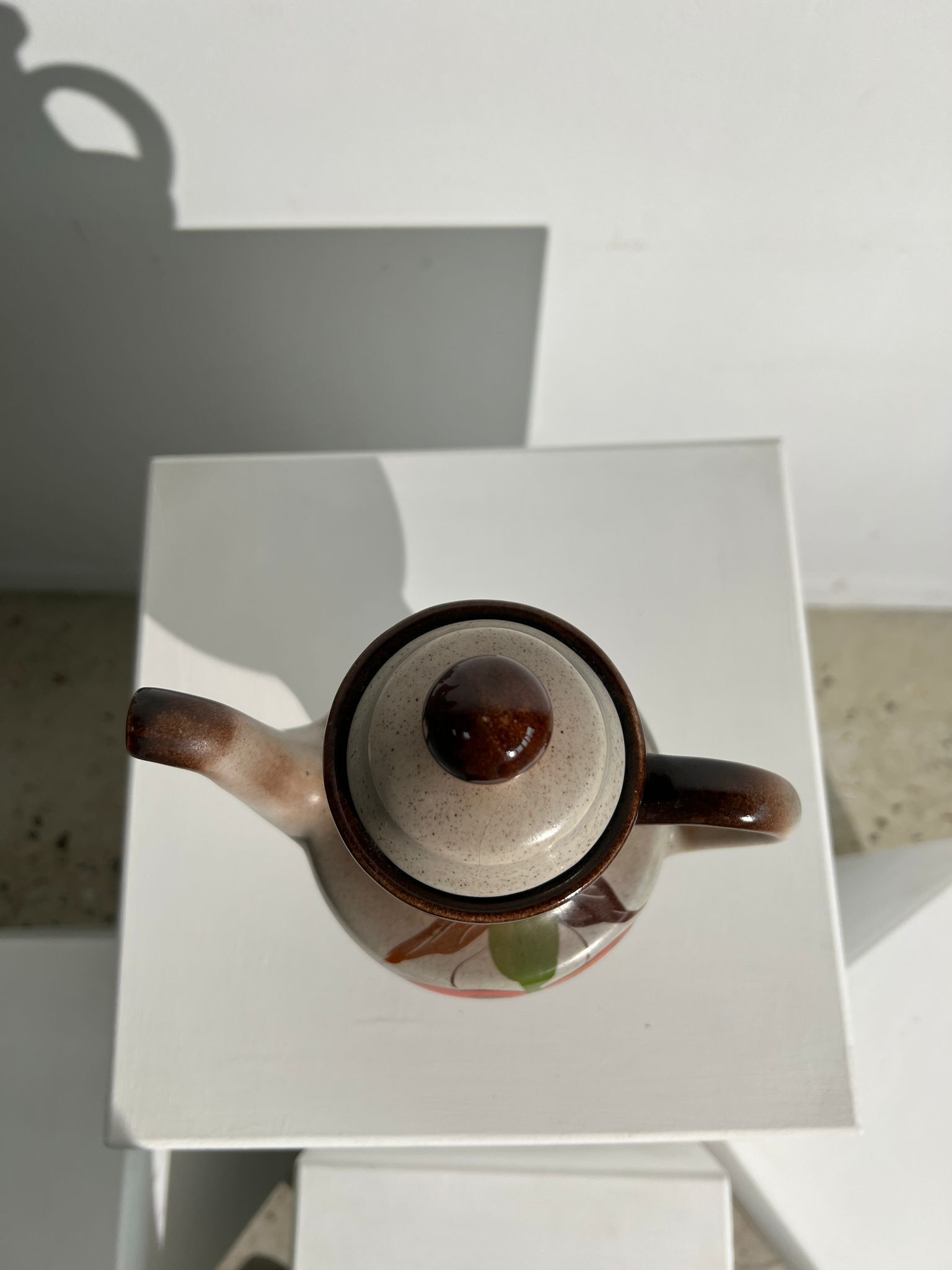 Vintage stoneware teapot with flower and fruit patterns