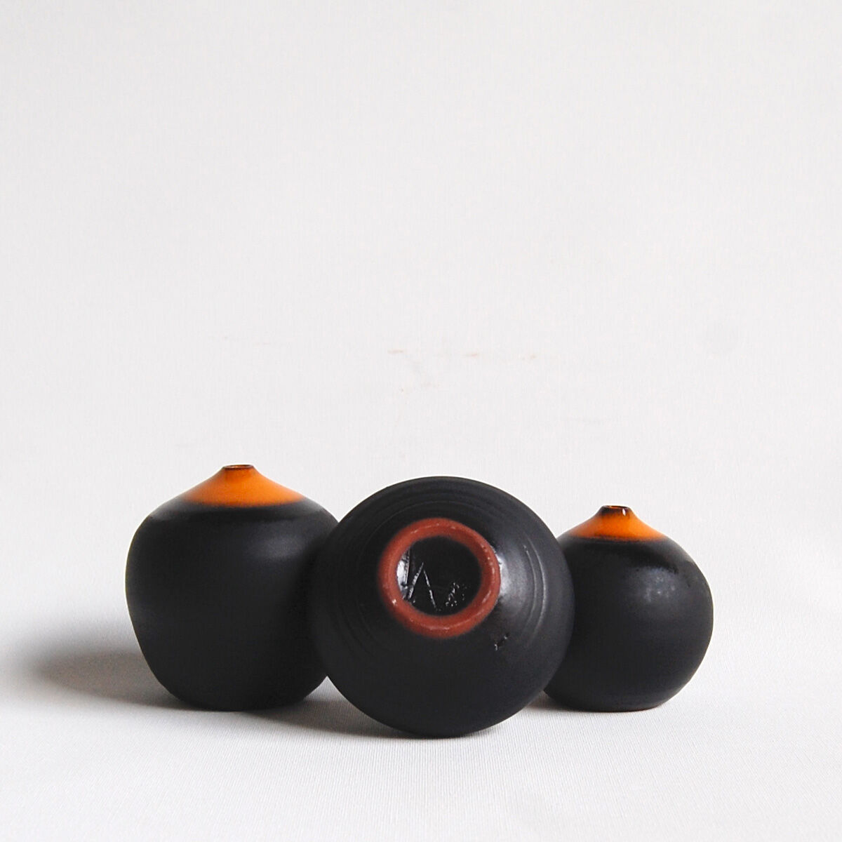 Trio of miniature black and orange ceramics Antonio Lampecco