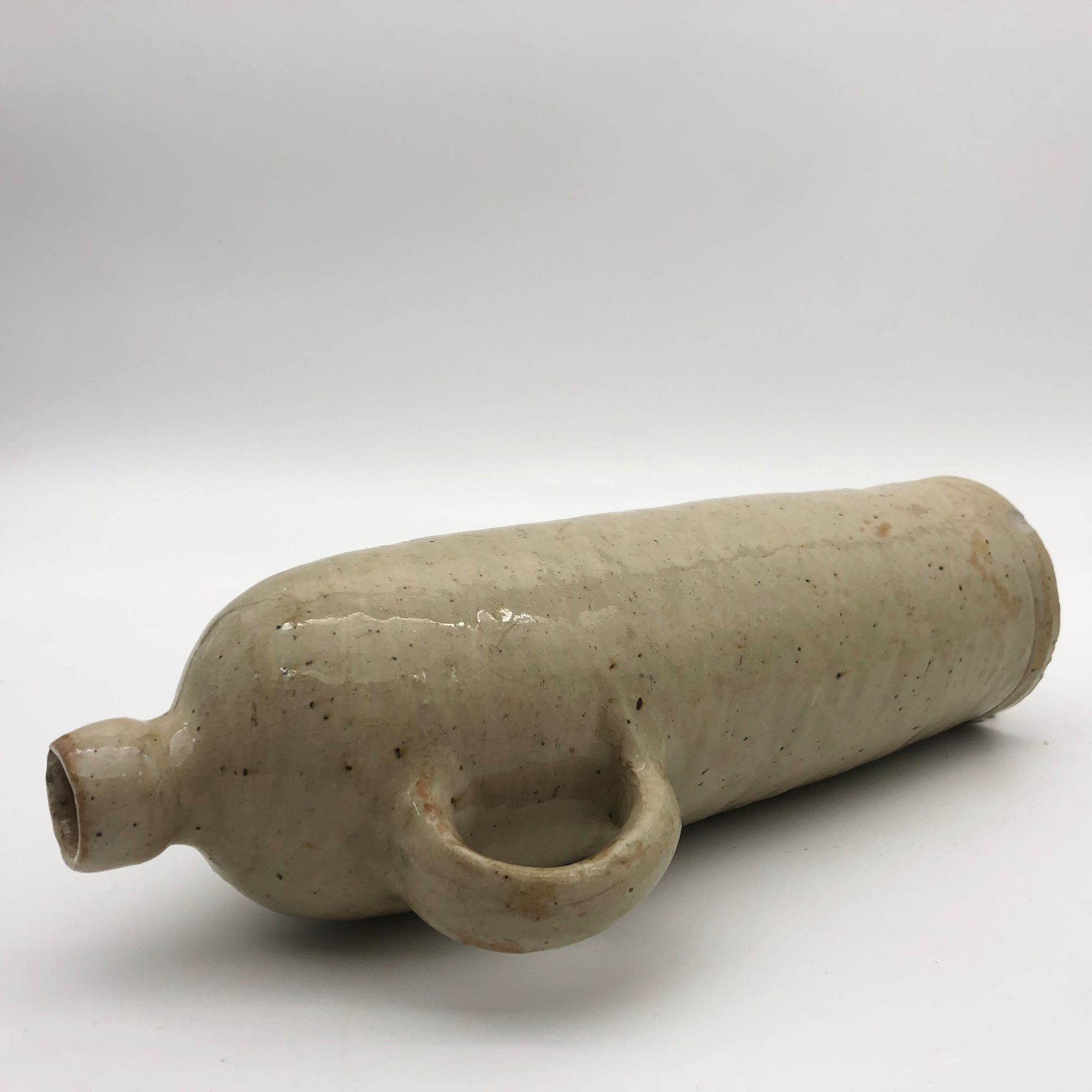 Old hot water bottle in glazed stoneware, beige color